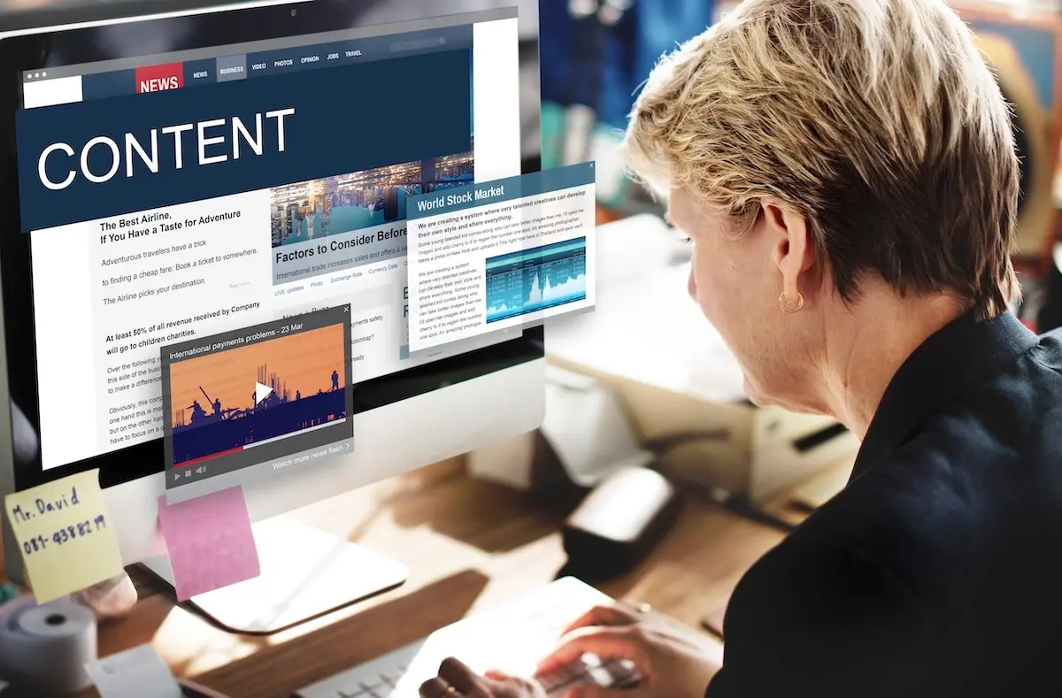 content marketing agency woman reading blog content on the computer. Content marketing agency services